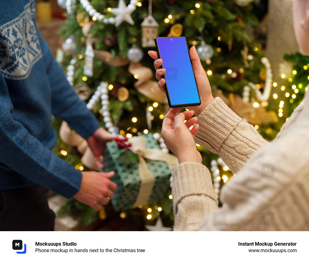 Phone mockup in hands next to the Christmas tree