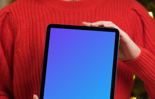 Female in red sweater holding an iPad Air mockup