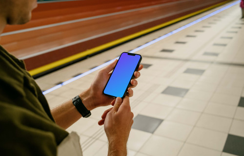 Man holding phone mockup at the subway station