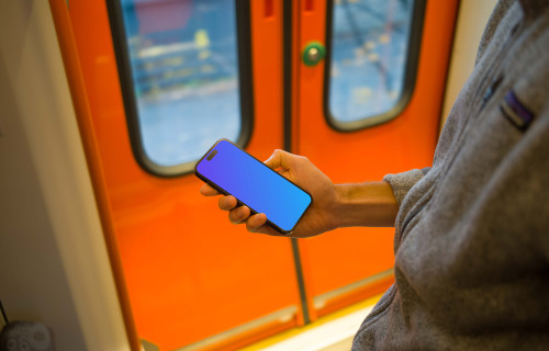 Man holding smartphone on the train