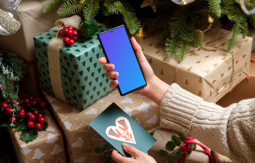 Woman holding Google Pixel 6 and gift card