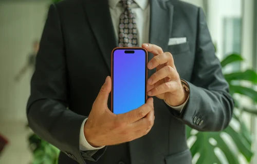 Businessman confidently holding an iPhone mockup