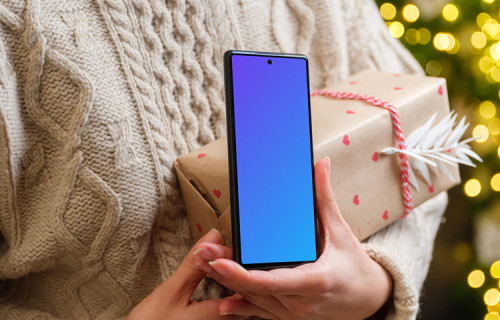 Female holding a Google Pixel and Christmas present mockup