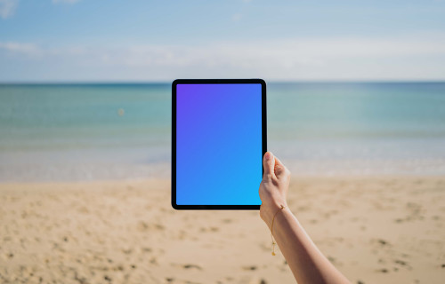 iPad Air mockup held by user at the beach 