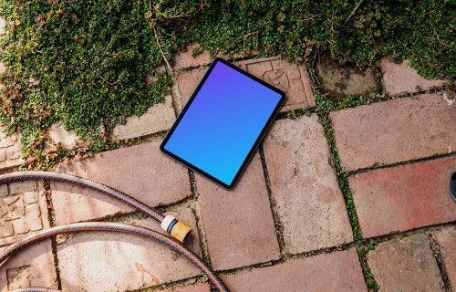 iPad Air mockup on a garden paving with plants