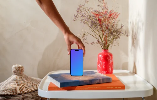 iPhone 15 Pro mockup in a woman's hand on a modern home setting