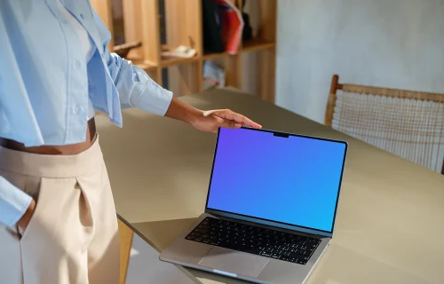 MacBook Pro 14 inch mockup with female hand on a modern desk