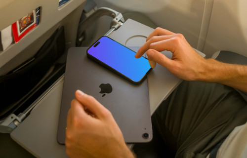 Man using iPhone 14 Pro mockup while sitting in airplane
