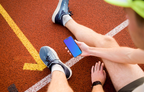 Runner holding a smartphone mockup