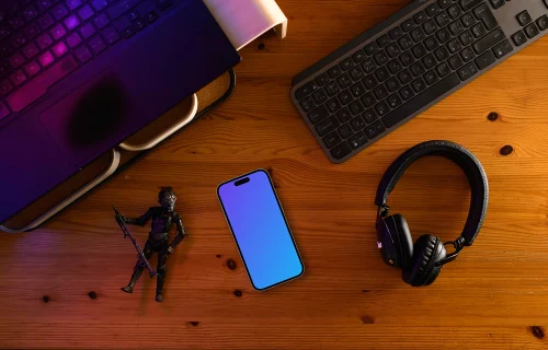 Smartphone mockup on a gamer's desk with action figure