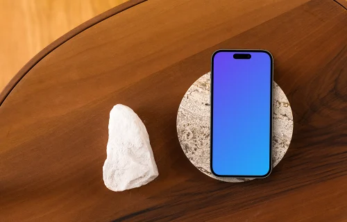 Smartphone mockup on wooden table with stone coaster