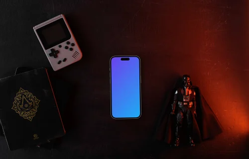 Smartphone mockup with vintage gaming console and collectible figure