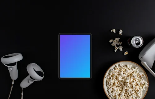 Tablet mockup with entertainment accessories on a dark background