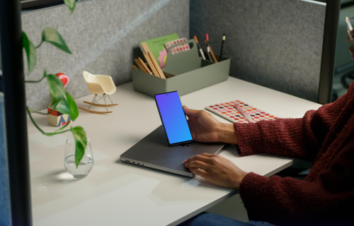Woman holding a Google Pixel 6 mockup in office