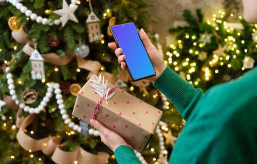 Woman holding a phone and Christmas present