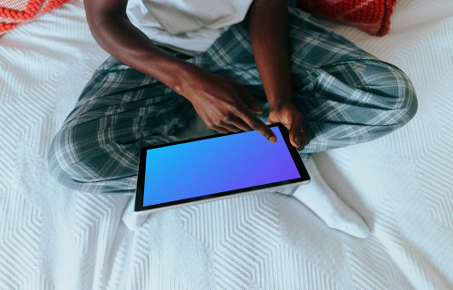 Microsoft Surface mockup held by a lady on her bed