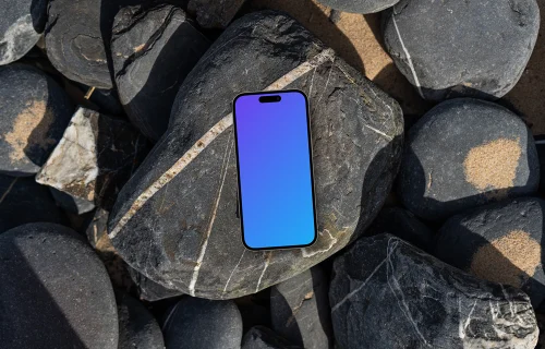 Smartphone mockup laying on a pile of rocks