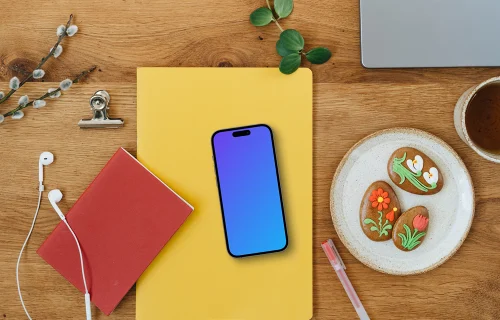 Smartphone mockup on a yellow notebook in an Easter settings