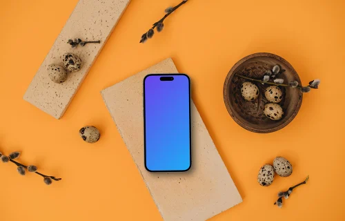 Smartphone mockup on an orange background with Easter decor