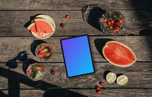 Top view of tablet mockup next to a watermeloon