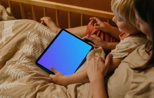 Child's hand holding an iPad Air mockup