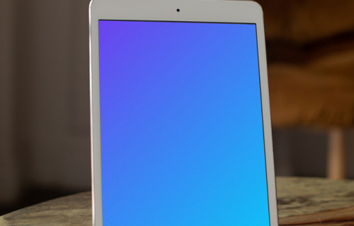 iPad Mini mockup on a stand with a chair in the background