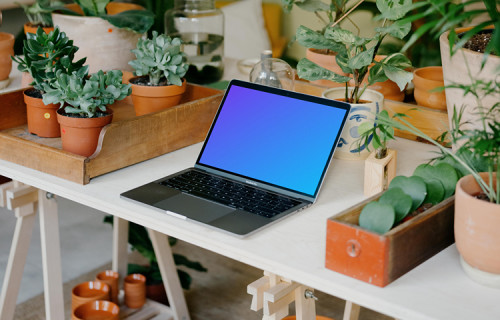 MacBook Pro Mockup between potted plants