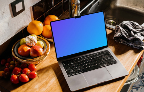 MacBook Pro mockup on a kitchen counter next to bowls of fruits