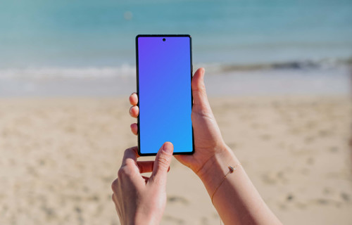 Pixel 6 mockup held by a user on a beach