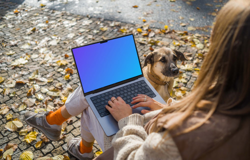 Woman sitting next to the dog with a MacBook Pro 14 mockup