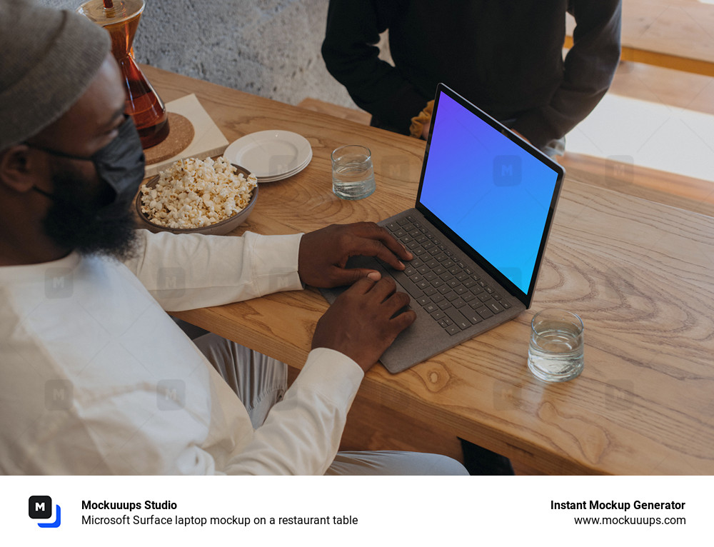 Microsoft Surface laptop mockup on a restaurant table