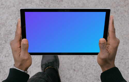 Microsoft Surface Laptop mockup held by a man