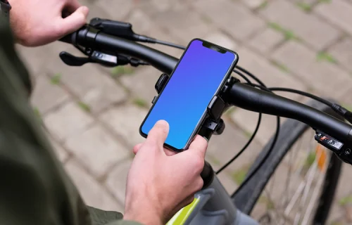 Assis sur le vélo, tapotant l'iPhone 11 Pro mockup dans le support de vélo