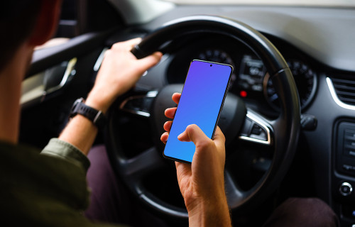 Driver tapping Samsung S20 mockup with hand on the wheel