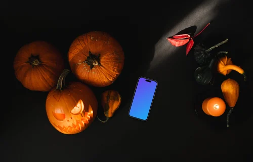 Halloween pumpkin mockup with a smartphone and candles