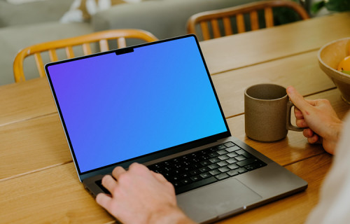 MacBook Pro mockup on a table in front of a user