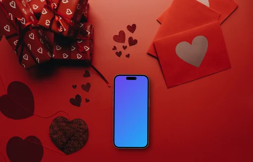 Smartphone mockup in a red scene with hearts and gifts