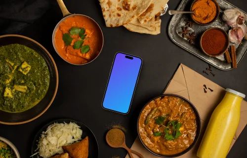 Smartphone mockup entouré de nourriture indienne