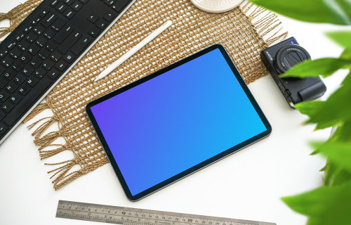 Tablet mockup beside a Canon camera