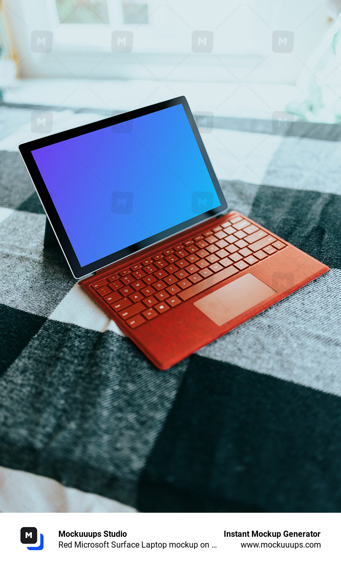 Red Microsoft Surface Laptop mockup on a bed